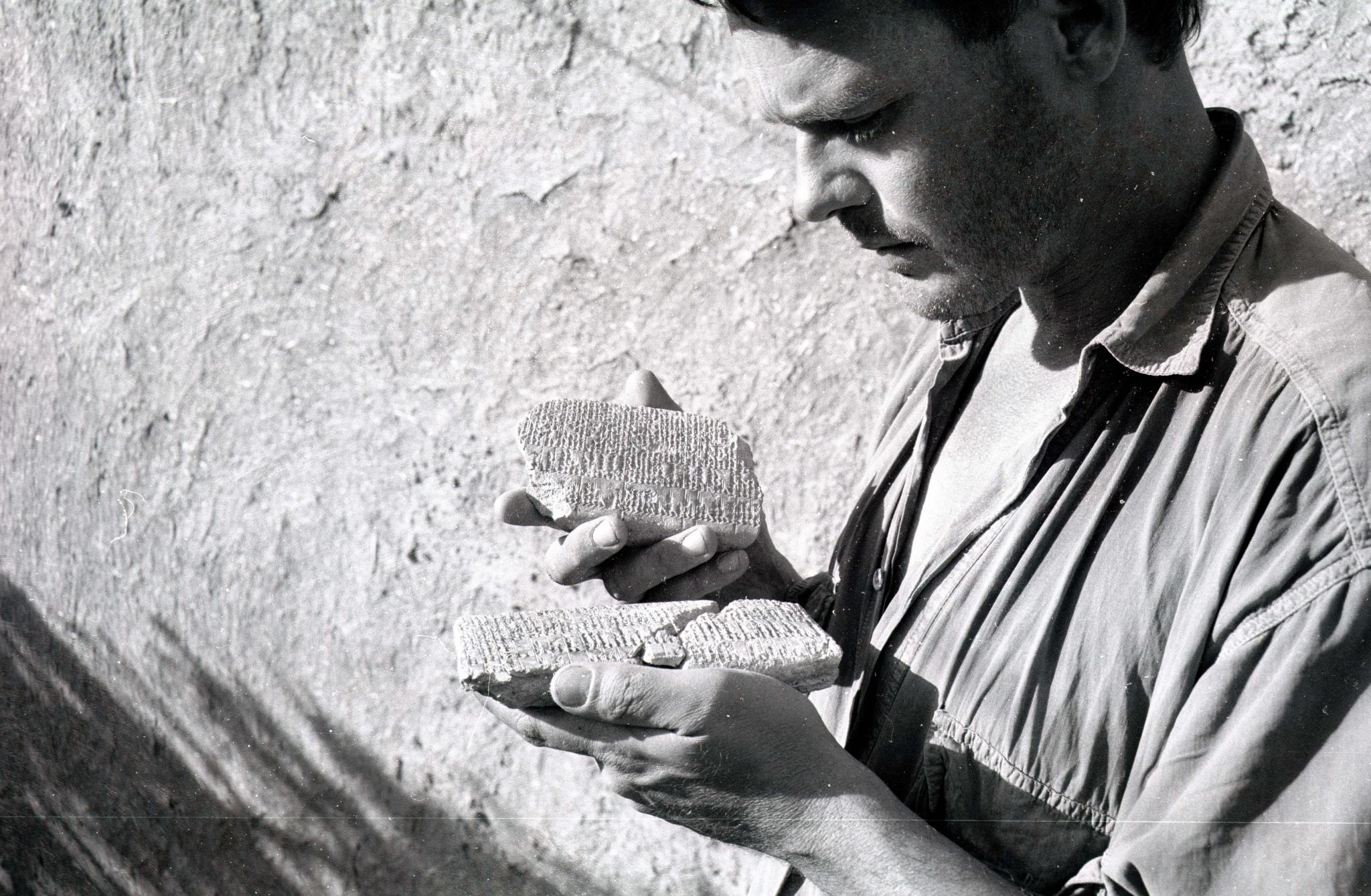 Peter Akkermans studying two clay tablets found at Tell Sabi Abyad